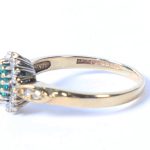 A 9 CARAT GOLD, EMERALD AND DIAMOND RING. 2